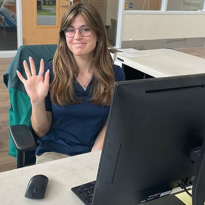 A GT female CRC staff member waving her hand.