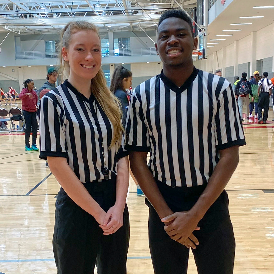 A young woman and young man intramural officials.