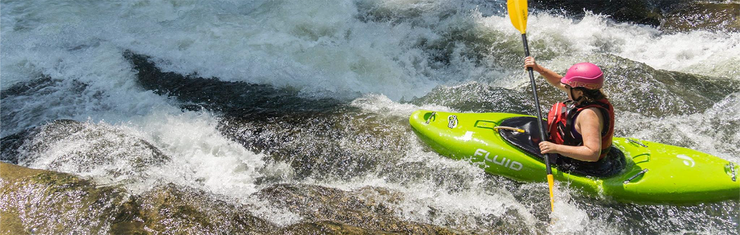 A person white water kayaking.
