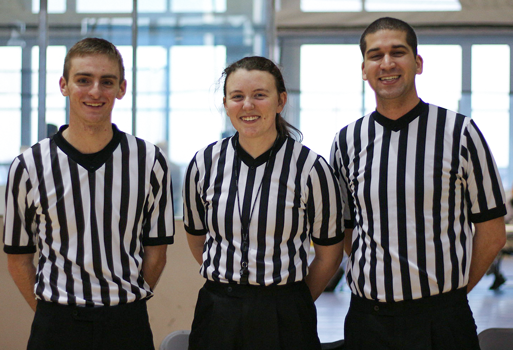 Two young men and one young women tournament officials.