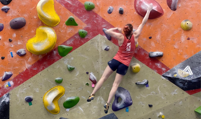 A young woman climbing.